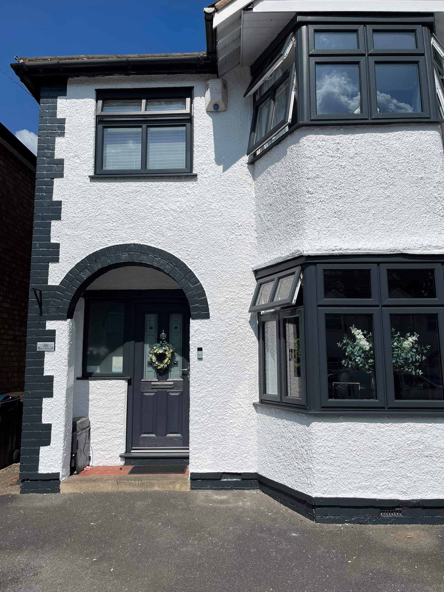 Exterior painting project — white rendered house with professional finish