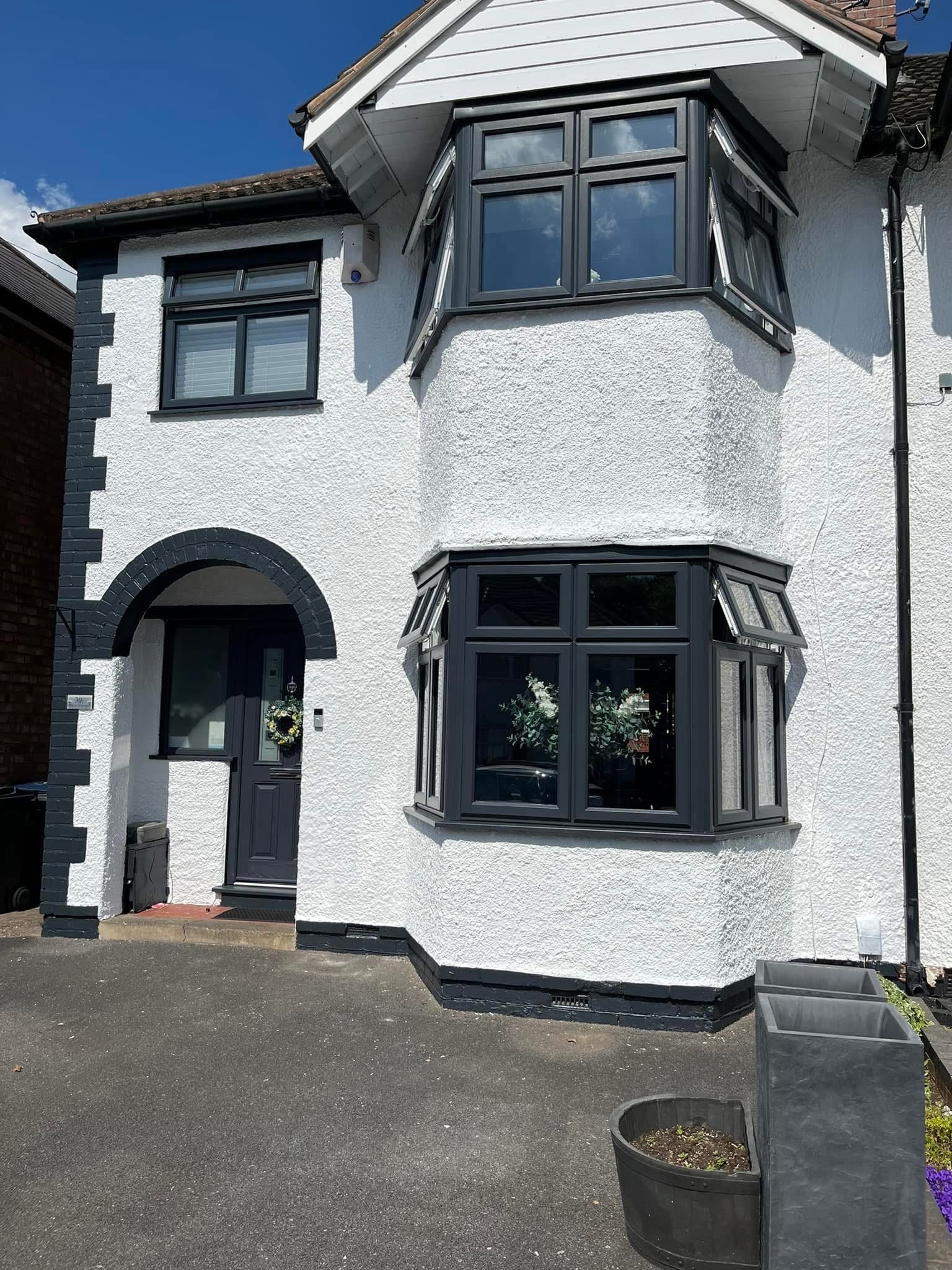 A Giffin Painting & Decorating — completed exterior painting project showing white rendered house with charcoal trim